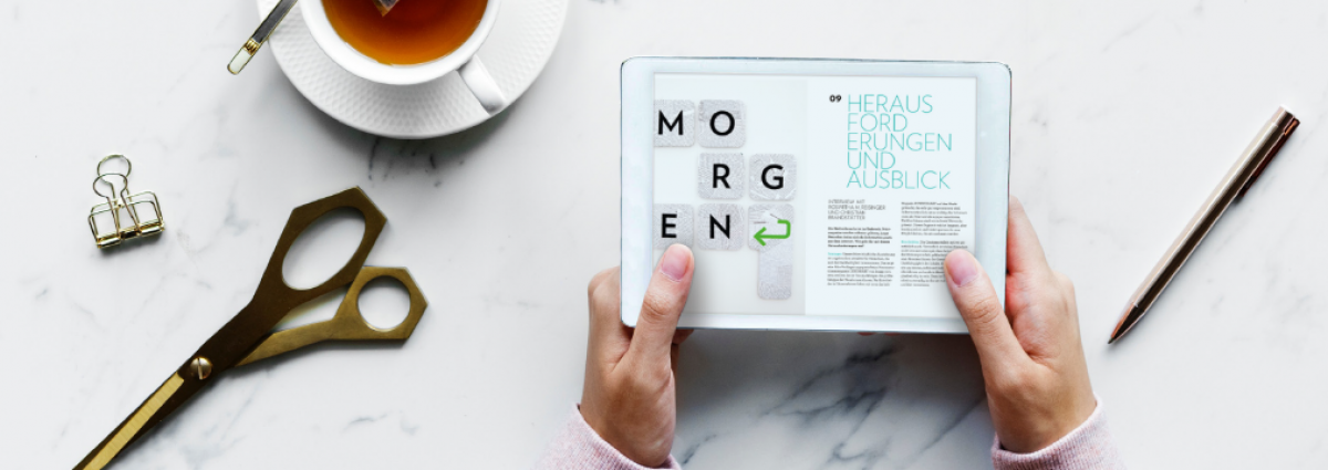 Man sieht Hände, die ein Tablet halten, auf dem 